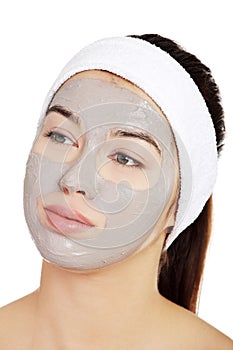 Beautiful woman with clay facial mask