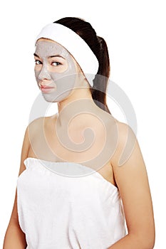 Beautiful woman with clay facial mask