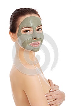 Beautiful woman with clay facial mask