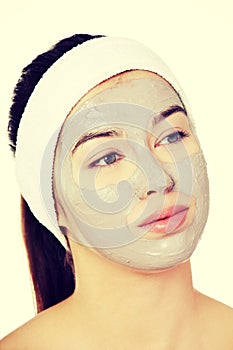 Beautiful woman with clay facial mask