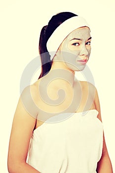 Beautiful woman with clay facial mask