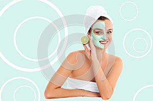 Beautiful woman with clay mask on pastel green background. Beauty and spa