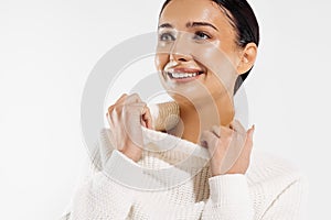 Beautiful woman with clean fresh skin smiling on a white background, beauty portrait of a female face with natural skin