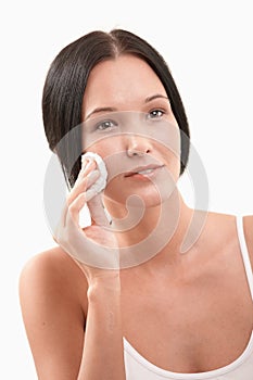 Beautiful woman cleaning face