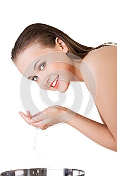 Beautiful woman is cleaning her face