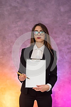 Beautiful woman with clipboard offering sign a contract with pen