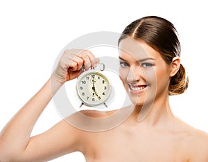 Beautiful woman with clock close up, smiling