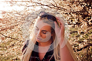 beautiful woman with closed eyes and bare shoulders, outdoor portrait. beauty, lifestyle and fashion concept