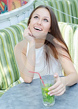 Beautiful woman with cocktail in cafe