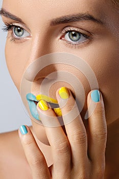 Beautiful woman with colorful nails and lips