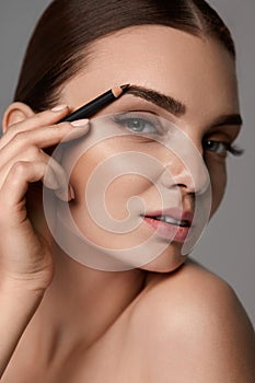 Beautiful Woman Contouring Eyebrows. Glamorous Makeup