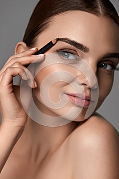 Beautiful Woman Contouring Eyebrows. Glamorous Makeup