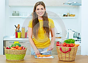 Beautiful woman cooking healthy food in home kitchen.