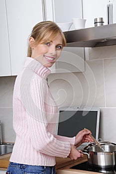 Beautiful woman cooking in a modern kitchen