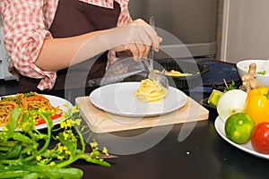 Beautiful woman cooking in new kitchen making healthy food with