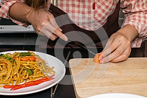 Beautiful woman cooking in new kitchen making healthy food with