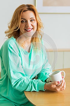 Beautiful woman with cup of hot tea