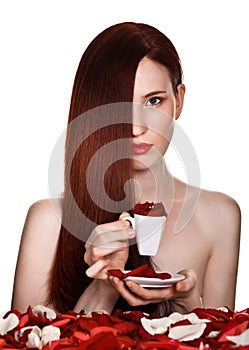 Beautiful woman and cup of rose petals