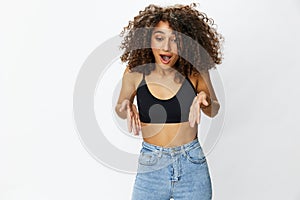 Beautiful woman with curly afro hair posing on a white  background smile happiness in jeans and black top