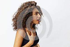 Beautiful woman with curly afro hair posing on a white  background smile happiness in jeans and black top