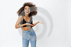 Beautiful woman with curly afro hair posing on a white isolated background smile happiness in jeans and black top