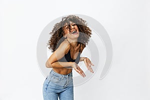 Beautiful woman with curly afro hair posing on a white isolated background smile happiness in jeans and black top