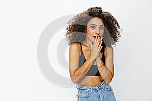Beautiful woman with curly afro hair posing on a white isolated background smile happiness in jeans and black top