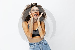 Beautiful woman with curly afro hair posing on a white isolated background smile happiness in jeans and black top