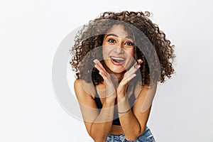 Beautiful woman with curly afro hair posing on a white isolated background smile happiness in jeans and black top