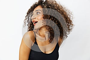 Beautiful woman with curly afro hair posing on a white isolated background smile happiness in jeans and black top