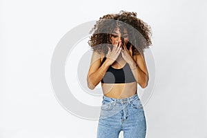 Beautiful woman with curly afro hair posing on a white isolated background smile happiness in jeans and black top