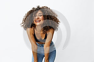 Beautiful woman with curly afro hair posing on a white isolated background smile happiness in jeans and black top