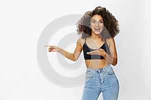 Beautiful woman with curly afro hair posing on a white isolated background smile happiness in jeans and black top