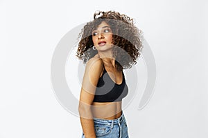 Beautiful woman with curly afro hair posing on a white isolated background smile happiness in jeans and black top