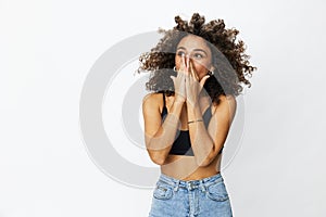 Beautiful woman with curly afro hair posing on a white isolated background smile happiness in jeans and black top