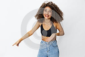 Beautiful woman with curly afro hair posing on a white isolated background smile happiness in jeans and black top