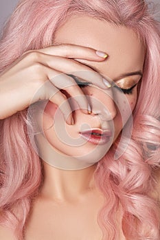 Beautiful Woman with Curly Colored Hairstyle and Fashion Make-up. Beauty Soft-Girl Style with Tender Pink Hair