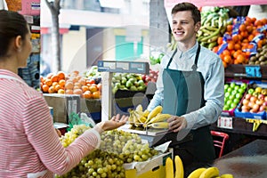 Beautiful woman customer buying yellow bananas