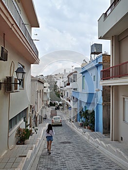 Beautiful woman in cute streets of Agios Nikolaos, Crete, Greece. Traveling to Europe.