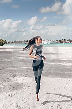 Beautiful woman with dark hair in sport suit relaxing on Maldive