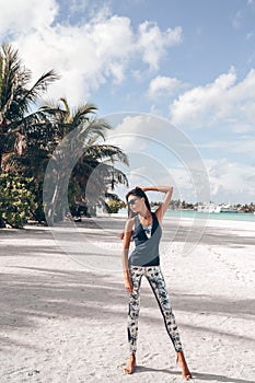 Beautiful woman with dark hair in sport suit relaxing on Maldive