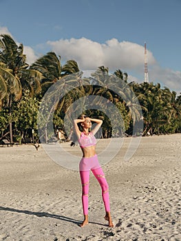 Beautiful woman with dark hair in sport suit relaxing on Maldive