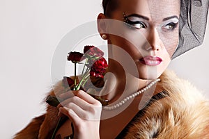 Beautiful woman with dark red roses