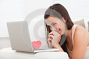 Beautiful woman dating online on laptop