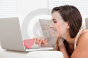 Beautiful woman dating online on laptop