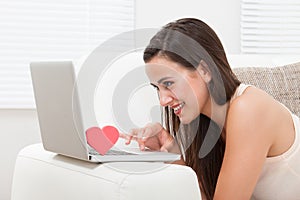 Beautiful woman dating online on laptop