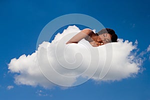 Beautiful woman deeply asleep and dreaming on Cloud nine