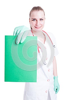 Beautiful woman doctor smiling and holding an empty cardboard