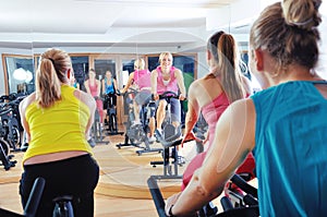 Beautiful woman doing exercise in a spinning class