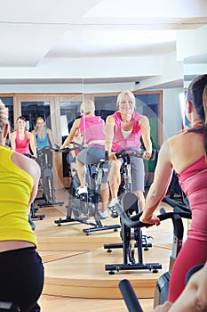 Beautiful woman doing exercise in a spinning class